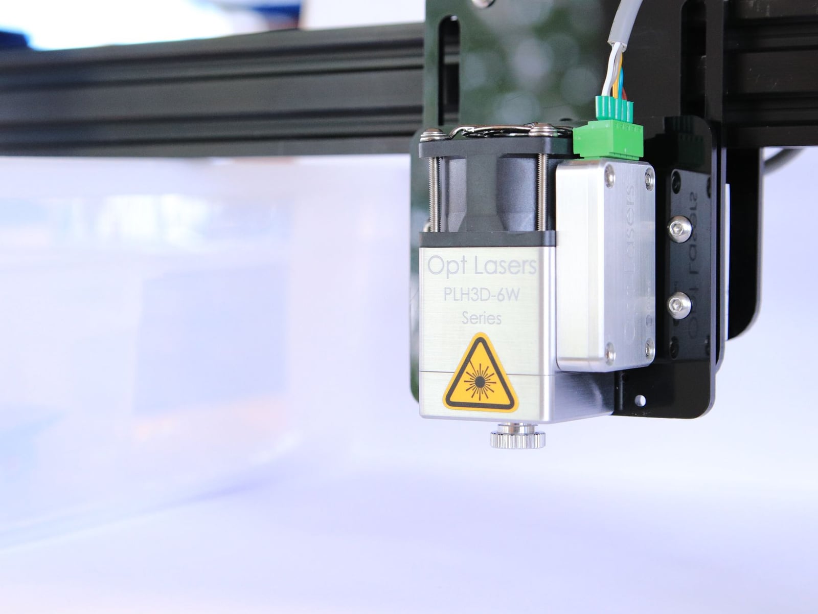 A laser machine head in motion, illustrating the process that determines project pricing.